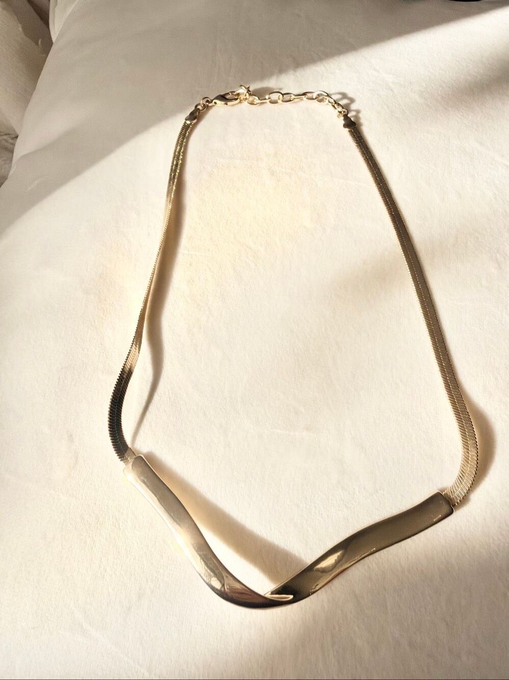 Mod style slick gold color statement necklace with snake chain